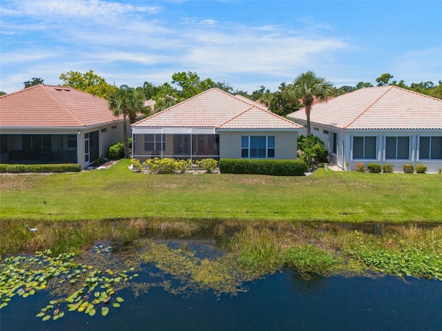 7164 Rue De Palisades Unit 5, Sarasota, FL 34238 - back of property featuring a tiled roof, a yard, a sunroom, stucco siding, and a water view
