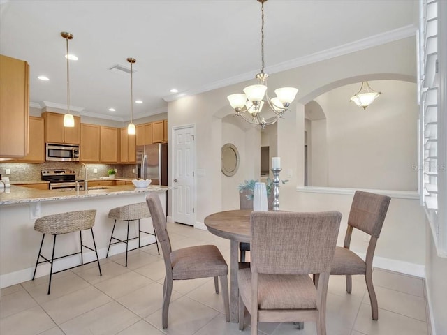 635 Chipper Dr, Sun City Center, FL 33573 - dining room featuring a chandelier, crown molding, arched walkways, baseboards, and light tile patterned flooring