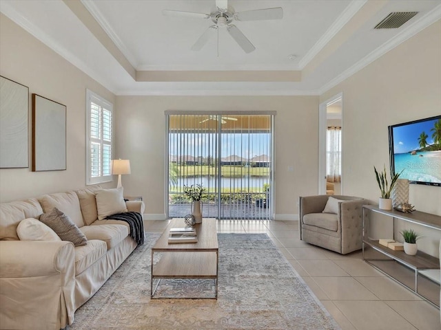 635 Chipper Dr, Sun City Center, FL 33573 - tiled living area featuring a tray ceiling, ceiling fan, ornamental molding, and baseboards