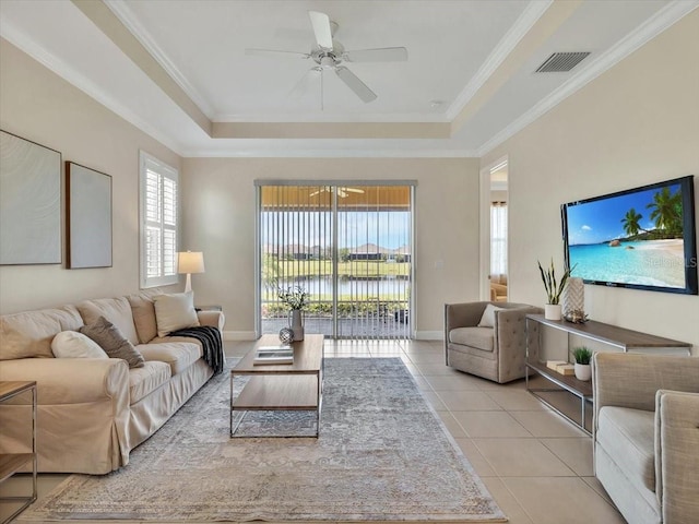 635 Chipper Dr, Sun City Center, FL 33573 - living area featuring a tray ceiling, healthy amount of natural light, light tile patterned floors, ceiling fan, and ornamental molding