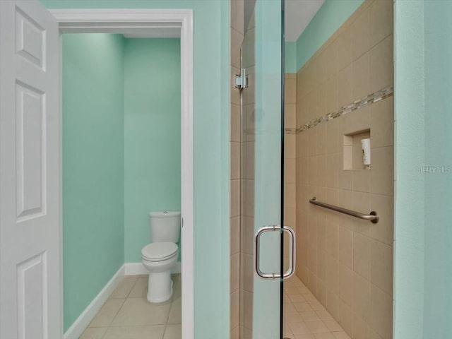 635 Chipper Dr, Sun City Center, FL 33573 - bathroom with a stall shower, toilet, tile patterned floors, and baseboards