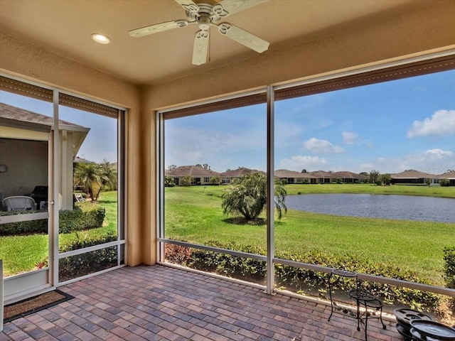 635 Chipper Dr, Sun City Center, FL 33573 - unfurnished sunroom with a water view, ceiling fan, and a residential view