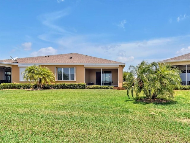 635 Chipper Dr, Sun City Center, FL 33573 - back of house with a lawn and stucco siding