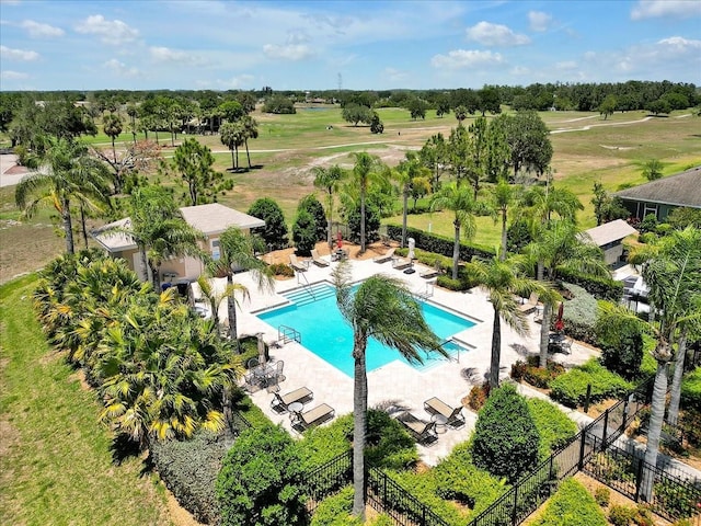 635 Chipper Dr, Sun City Center, FL 33573 - community pool with fence, a patio area, and view of scattered trees