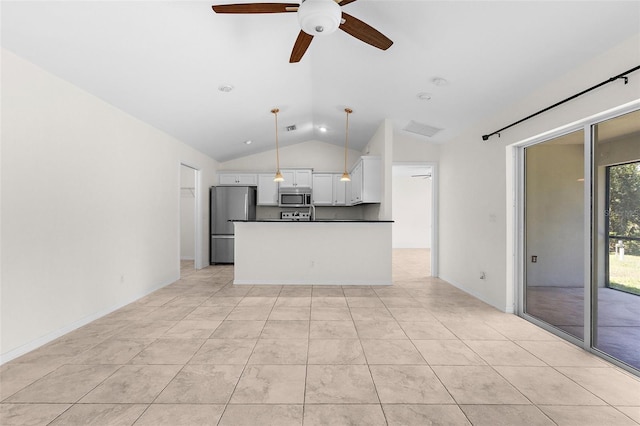 2575 Johannesberg Rd, North Port, FL 34288 - kitchen with stainless steel appliances, vaulted ceiling, white cabinets, dark countertops, and ceiling fan