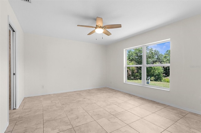 2575 Johannesberg Rd, North Port, FL 34288 - unfurnished room with ceiling fan, light tile patterned floors, and baseboards
