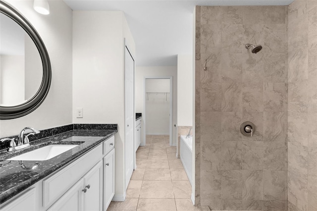 2575 Johannesberg Rd, North Port, FL 34288 - full bathroom with a tile shower, vanity, a spacious closet, tile patterned floors, and a bath