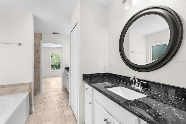 2575 Johannesberg Rd, North Port, FL 34288 - bathroom featuring vanity, tile patterned flooring, and a garden tub