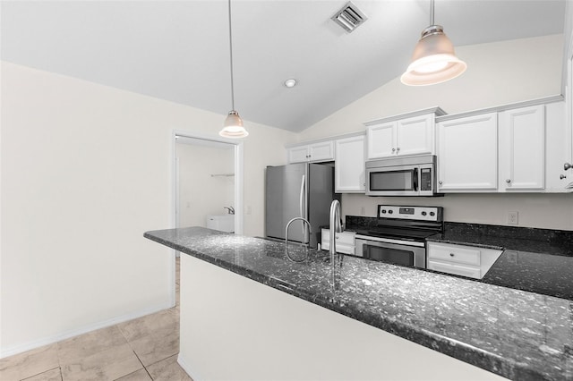 2575 Johannesberg Rd, North Port, FL 34288 - kitchen featuring appliances with stainless steel finishes, white cabinetry, lofted ceiling, dark stone counters, and decorative light fixtures