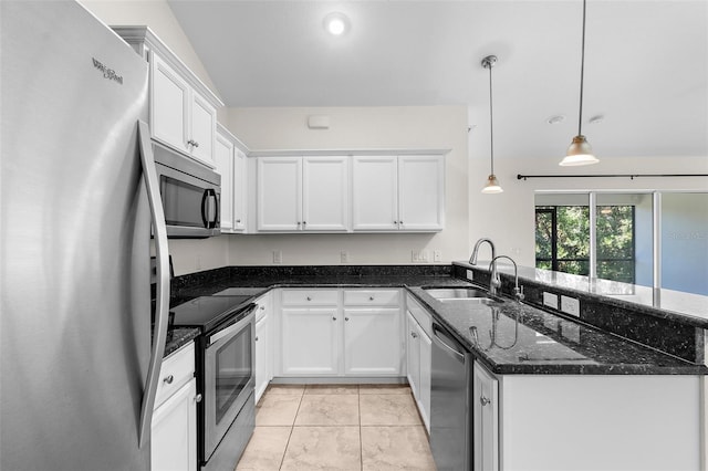2575 Johannesberg Rd, North Port, FL 34288 - kitchen with stainless steel appliances, a sink, a peninsula, white cabinets, and dark stone counters