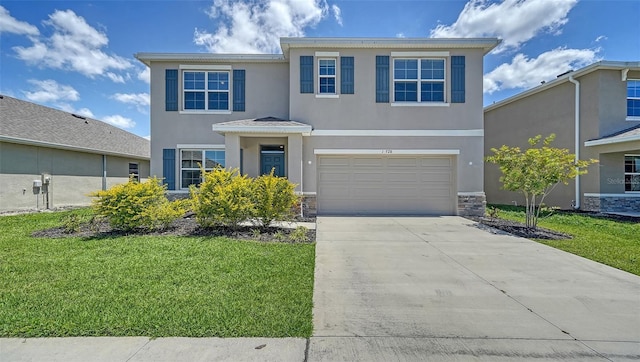 12728 Lateral Root Dr, Sarasota, FL 34238 - traditional-style house featuring stucco siding, driveway, a garage, a front lawn, and stone siding