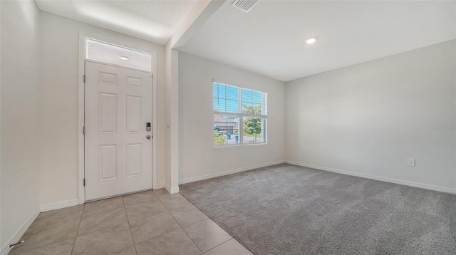 12728 Lateral Root Dr, Sarasota, FL 34238 - entryway featuring light colored carpet, baseboards, light tile patterned floors, and recessed lighting