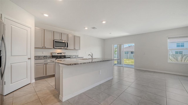 12728 Lateral Root Dr, Sarasota, FL 34238 - kitchen with stainless steel appliances, a sink, gray cabinets, light tile patterned flooring, and stone countertops