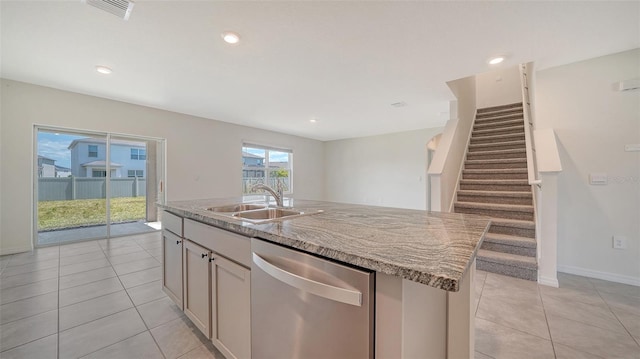 12728 Lateral Root Dr, Sarasota, FL 34238 - kitchen with dishwasher, a sink, light stone counters, light tile patterned floors, and recessed lighting