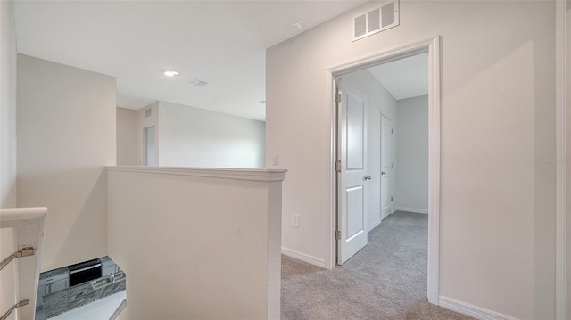 12728 Lateral Root Dr, Sarasota, FL 34238 - corridor featuring carpet, baseboards, and an upstairs landing