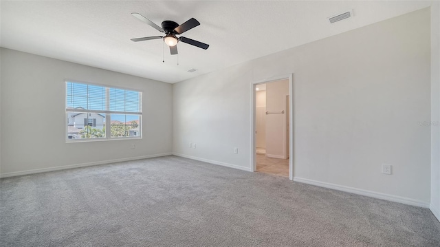12728 Lateral Root Dr, Sarasota, FL 34238 - spare room with light colored carpet, a ceiling fan, and baseboards