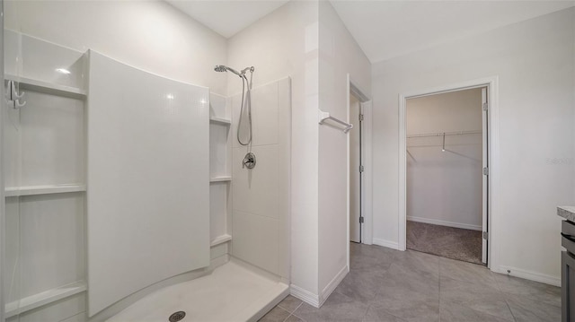 12728 Lateral Root Dr, Sarasota, FL 34238 - full bathroom with a shower stall, a spacious closet, and baseboards