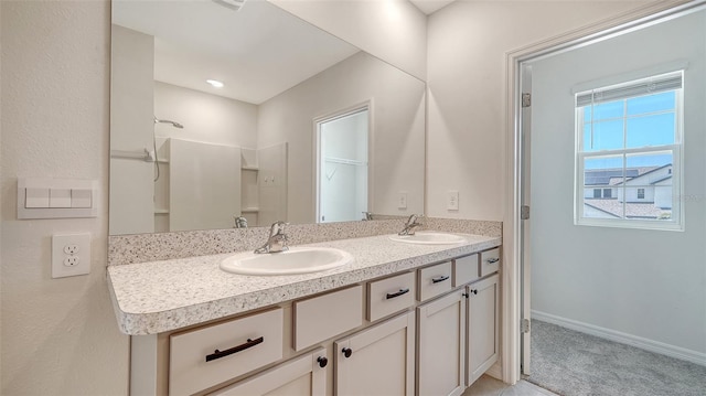 12728 Lateral Root Dr, Sarasota, FL 34238 - full bath with double vanity, baseboards, and a shower