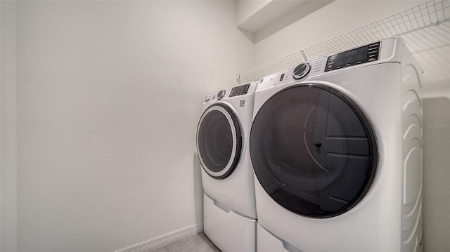 12728 Lateral Root Dr, Sarasota, FL 34238 - washroom featuring washing machine and clothes dryer and baseboards