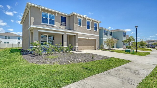12732 Lateral Root Dr, Sarasota, FL 34238 - view of front facade featuring stucco siding, covered porch, driveway, an attached garage, and a residential view