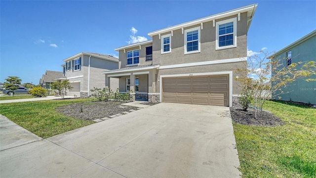 12732 Lateral Root Dr, Sarasota, FL 34238 - view of front of home with stucco siding, an attached garage, driveway, stone siding, and a porch