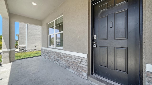 12732 Lateral Root Dr, Sarasota, FL 34238 - doorway to property with stone siding and stucco siding