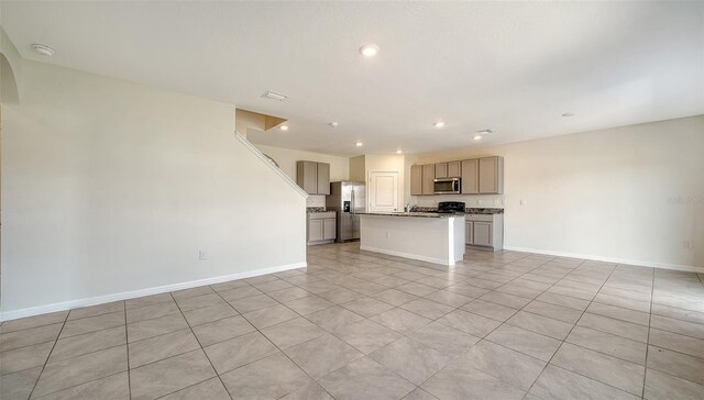 12732 Lateral Root Dr, Sarasota, FL 34238 - unfurnished living room with baseboards, recessed lighting, and light tile patterned floors