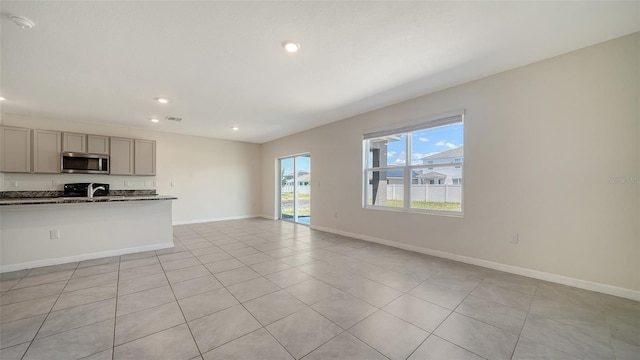12732 Lateral Root Dr, Sarasota, FL 34238 - unfurnished living room with recessed lighting, baseboards, and light tile patterned floors
