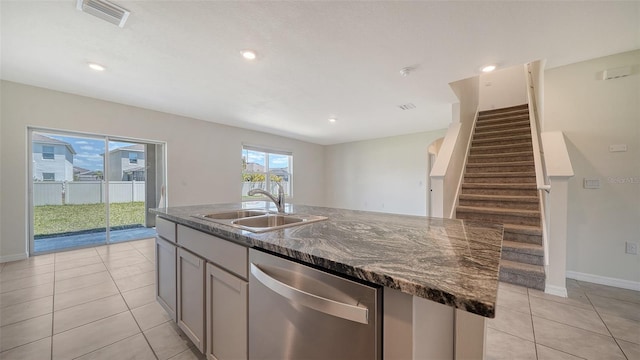 12732 Lateral Root Dr, Sarasota, FL 34238 - kitchen featuring dishwasher, a sink, light tile patterned floors, a kitchen island with sink, and baseboards