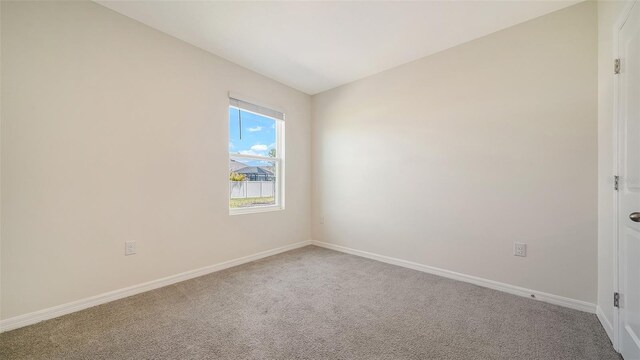 12732 Lateral Root Dr, Sarasota, FL 34238 - empty room with carpet floors and baseboards