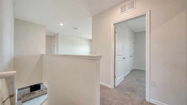 12732 Lateral Root Dr, Sarasota, FL 34238 - hallway with light carpet, baseboards, and an upstairs landing