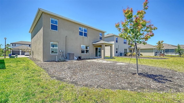 12732 Lateral Root Dr, Sarasota, FL 34238 - rear view of property featuring central air condition unit, stucco siding, and a yard