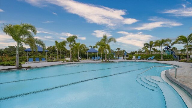 12732 Lateral Root Dr, Sarasota, FL 34238 - community pool featuring a patio area