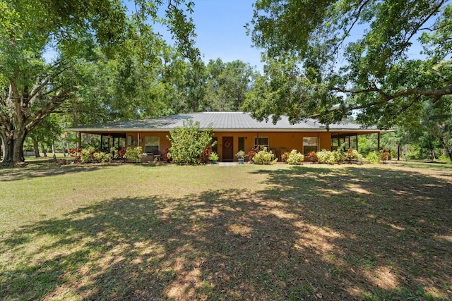 13719 Seminole Trl, Wimauma, FL 33598 - view of front of home with a front lawn and metal roof