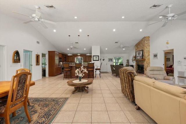 13719 Seminole Trl, Wimauma, FL 33598 - living room with ceiling fan, high vaulted ceiling, a stone fireplace, light tile patterned floors, and recessed lighting