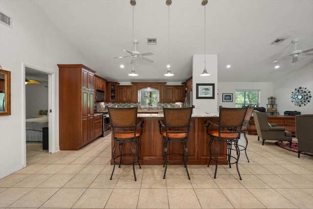 13719 Seminole Trl, Wimauma, FL 33598 - kitchen featuring ceiling fan, stainless steel appliances, tasteful backsplash, light tile patterned floors, and lofted ceiling