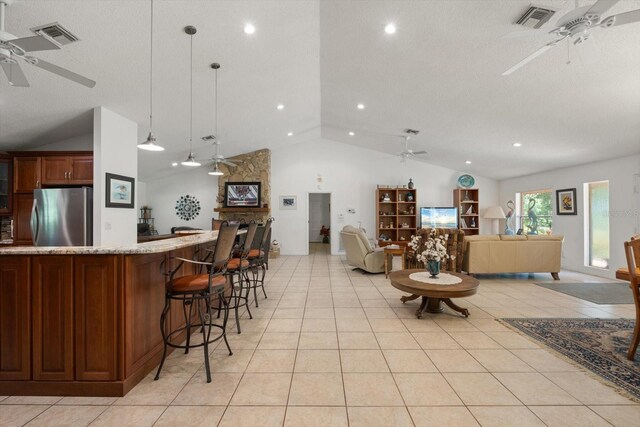 13719 Seminole Trl, Wimauma, FL 33598 - living room featuring ceiling fan, lofted ceiling, light tile patterned floors, bar, and recessed lighting