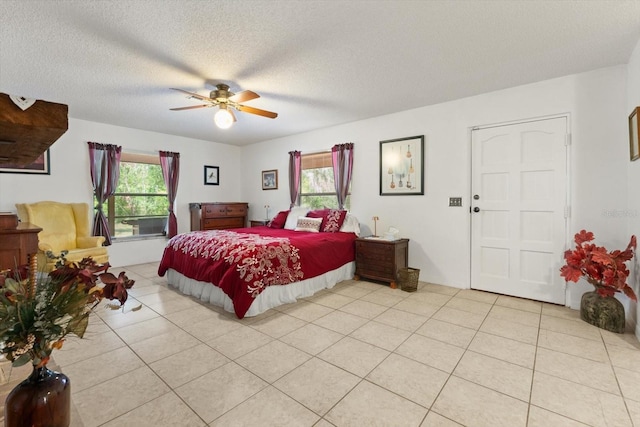 13719 Seminole Trl, Wimauma, FL 33598 - bedroom with light tile patterned floors, a textured ceiling, and a ceiling fan