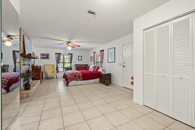 13719 Seminole Trl, Wimauma, FL 33598 - bedroom with a textured ceiling, light tile patterned floors, and a ceiling fan