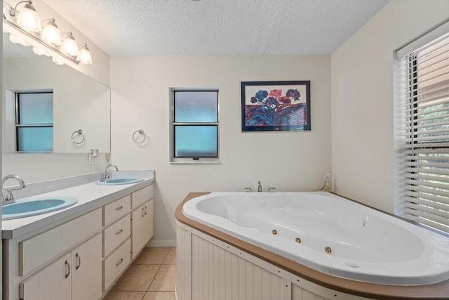 13719 Seminole Trl, Wimauma, FL 33598 - full bath featuring a textured ceiling, tile patterned flooring, a whirlpool tub, double vanity, and baseboards