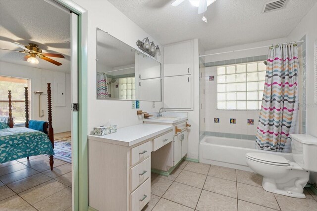 13719 Seminole Trl, Wimauma, FL 33598 - bathroom featuring a ceiling fan, a textured ceiling, tile patterned flooring, and plenty of natural light