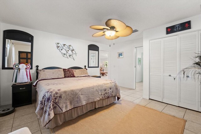 13719 Seminole Trl, Wimauma, FL 33598 - bedroom with light tile patterned floors, arched walkways, a closet, and ceiling fan