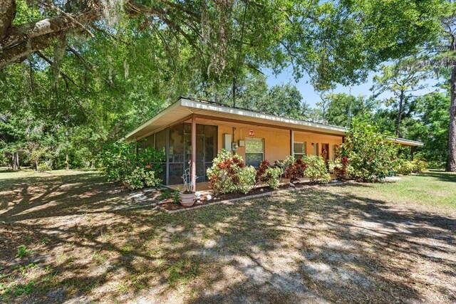 13719 Seminole Trl, Wimauma, FL 33598 - view of front of property featuring a sunroom and stucco siding