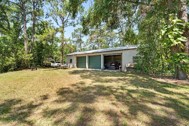 13719 Seminole Trl, Wimauma, FL 33598 - view of grassy yard with an outbuilding and a garage