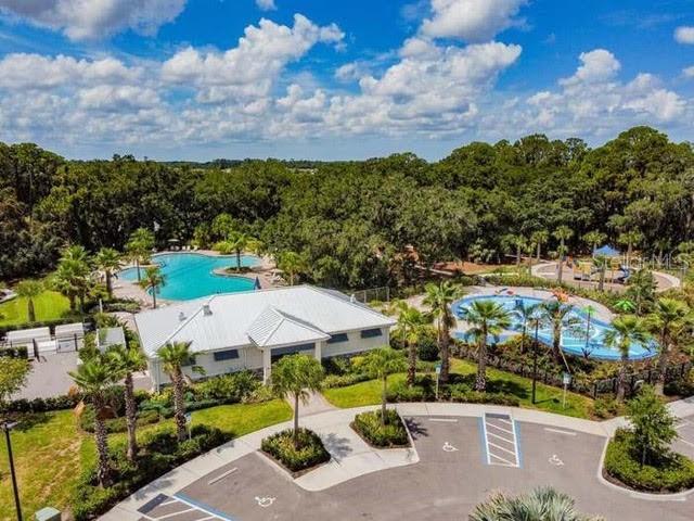 10962 High Noon Trl, Parrish, FL 34219 - bird's eye view of a pool area and a heavily wooded area