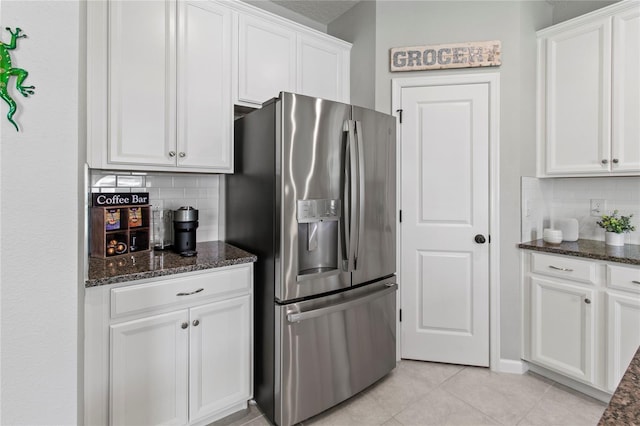 10962 High Noon Trl, Parrish, FL 34219 - kitchen with stainless steel fridge with ice dispenser, tasteful backsplash, white cabinets, and dark stone counters