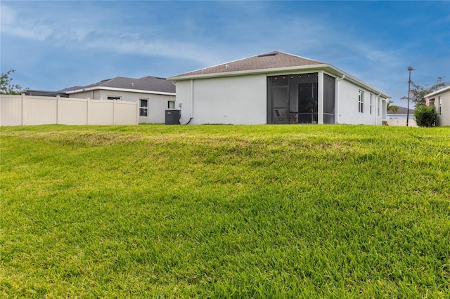10962 High Noon Trl, Parrish, FL 34219 - back of property featuring central AC unit, a sunroom, and stucco siding