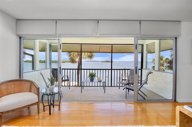 sunroom featuring a water view and healthy amount of natural light
