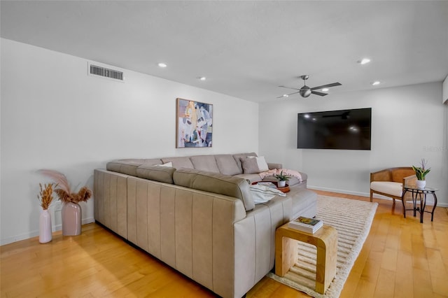 living room featuring a ceiling fan, light wood finished floors, recessed lighting, and baseboards