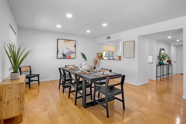 dining area featuring light wood-type flooring, recessed lighting, and baseboards